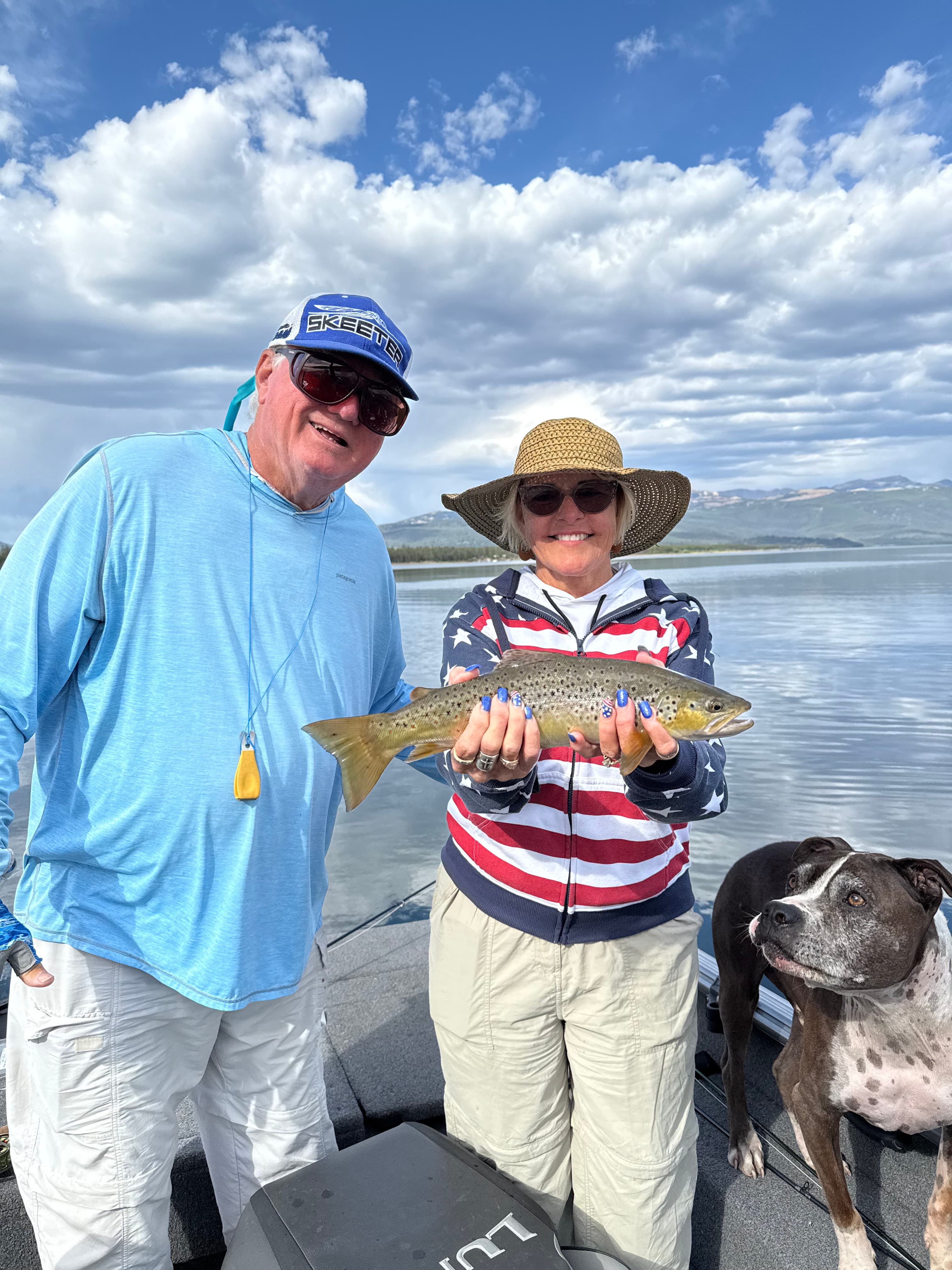 Happy anglers with brown trout on Hebgen Lake